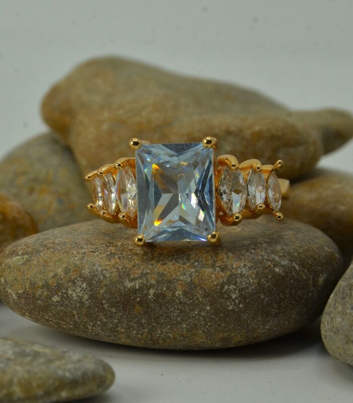 Gold-plated zircon ring featuring a large emerald-cut center stone flanked by marquise-cut side accents for a luxurious look.