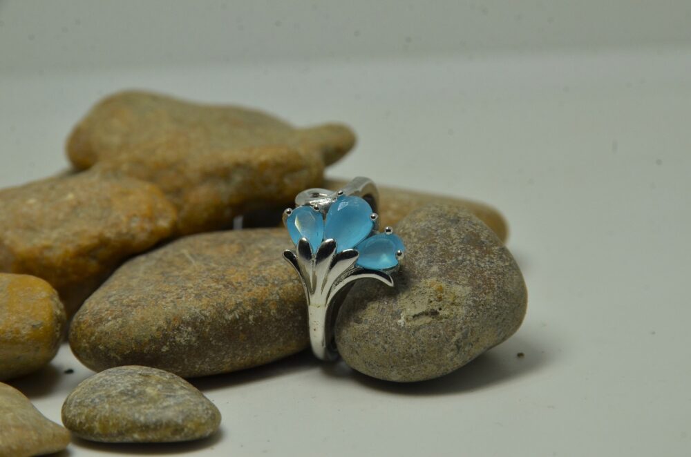 Elegant silver ring featuring three pear-shaped blue zircon stones in a floral-inspired design. - Image 2