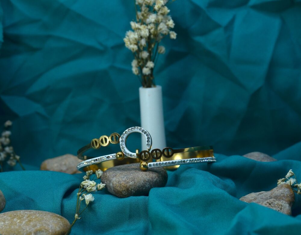 Stylish gold and silver-toned bracelet pair featuring screw motifs and a sparkling circular charm centerpiece. - Image 2