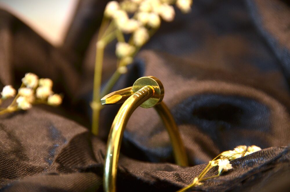 Stylish gold Cartier nail bracelet featuring a sleek, industrial-inspired design with a polished finish - Image 2