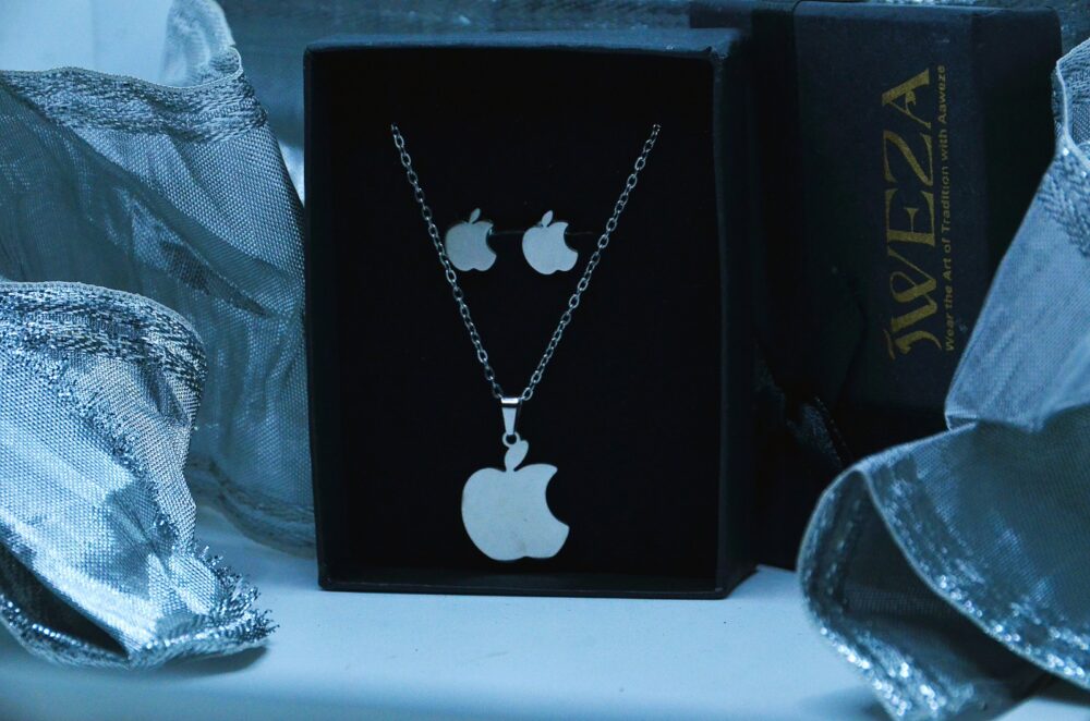 Trendy silver jewelry set featuring an apple-shaped pendant and matching stud earrings in a sleek, modern design. - Image 2