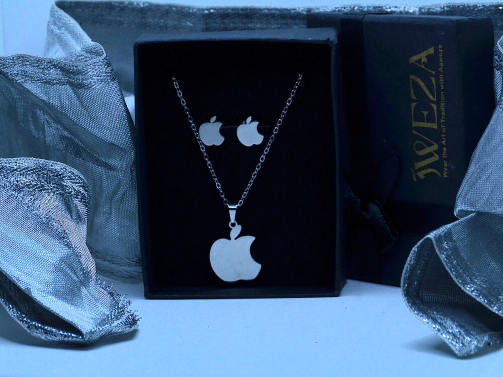 Trendy silver jewelry set featuring an apple-shaped pendant and matching stud earrings in a sleek, modern design.