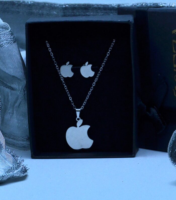 Trendy silver jewelry set featuring an apple-shaped pendant and matching stud earrings in a sleek, modern design.