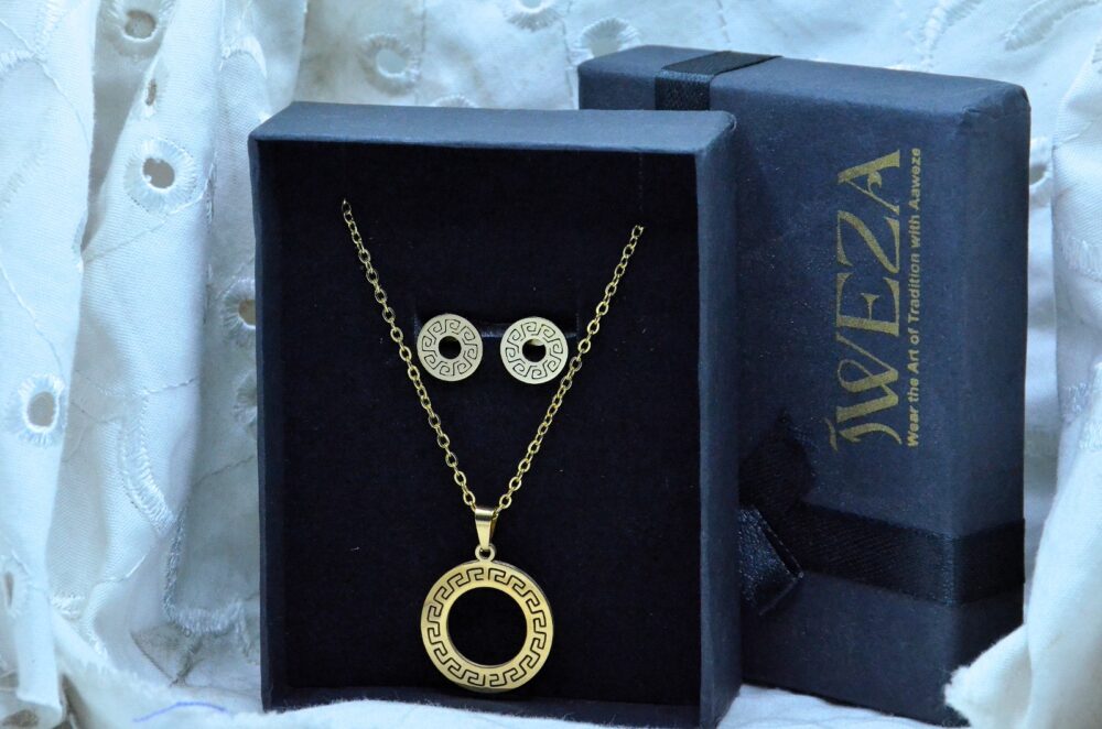 Classic gold jewelry set featuring a circular pendant and matching earrings with intricate Greek key patterns. - Image 2