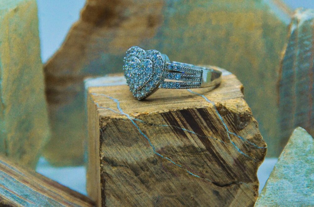 Elegant silver ring adorned with a sparkling double-layered heart design encrusted with zircon stones. - Image 2