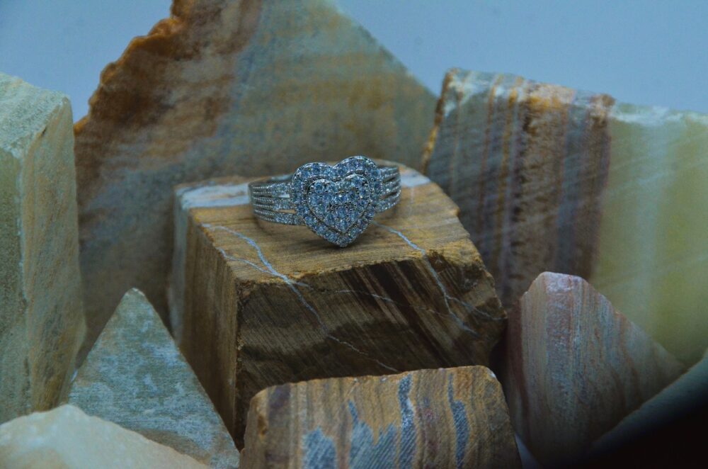 Elegant silver ring adorned with a sparkling double-layered heart design encrusted with zircon stones.