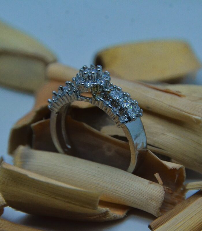 Elegant silver ring adorned with a row of shimmering white zircon stones, perfect for timeless sophistication.]