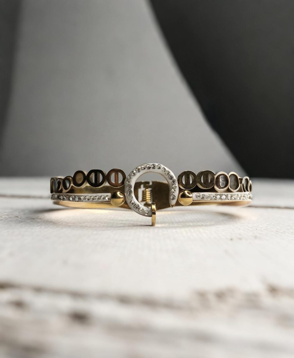 Stylish gold and silver-toned bracelet pair featuring screw motifs and a sparkling circular charm centerpiece.